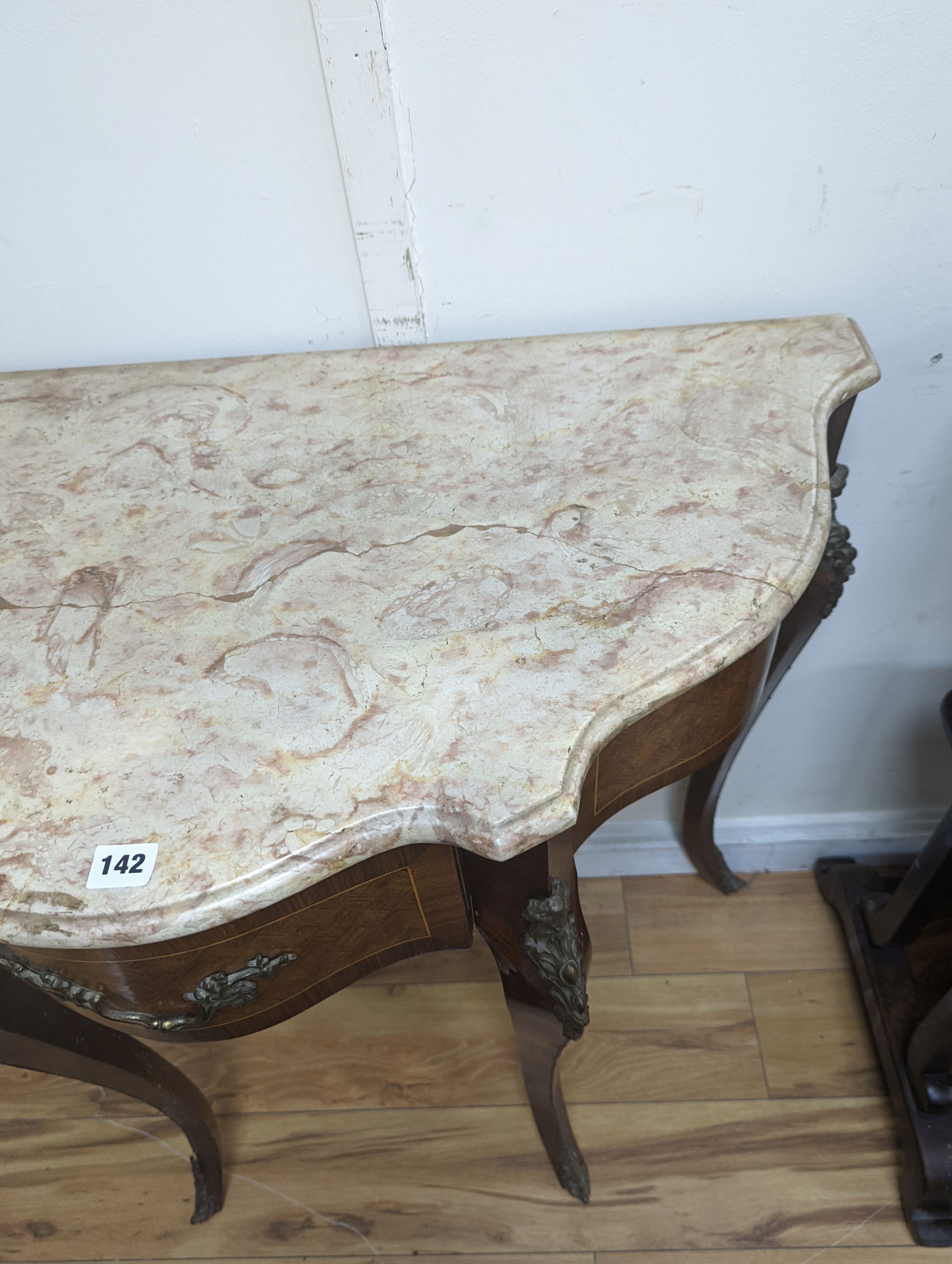 A Louis XVI design marble top serpentine console table. W-102cm, D-47cm, H-91cm.
